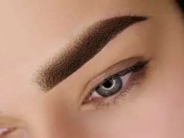 Close-up of softly shaded powder brow permanent makeup.