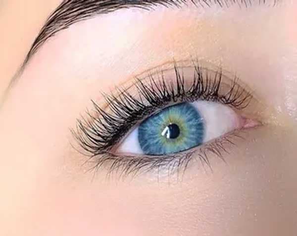Close-up of tinted natural lashes on a blue eye.