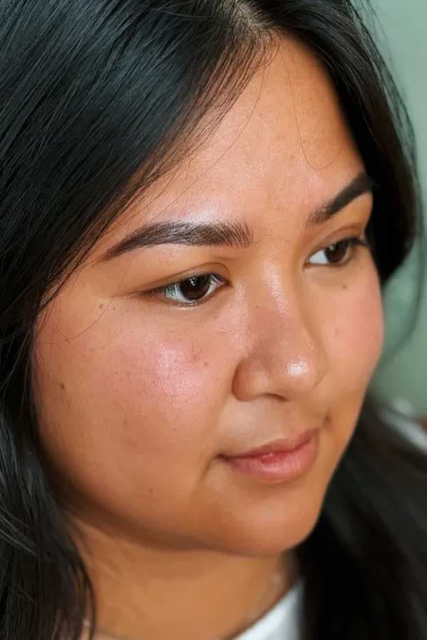 Close-up of combination nano brow permanent makeup with fine hair-stroke detail.